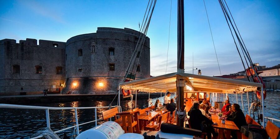 Dubrovnik: Panoramic Sunset Cocktail Cruise Around Old Town - Passing the Old Town walls from offshore