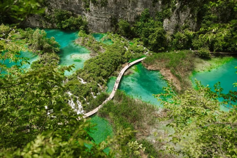 From Zagreb: Plitvice Lakes National Park Tour with Tickets - Boats, panoramic transport, and seasonal limits