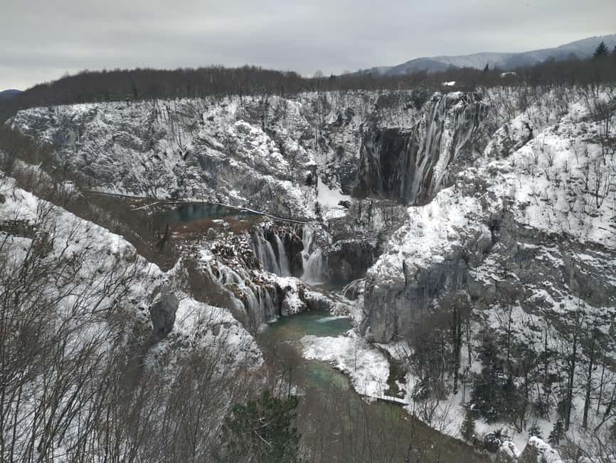 Plitvice Lakes: Guided Walking Tour with Boat Ride - Walking the wooden paths beside the lower lakes