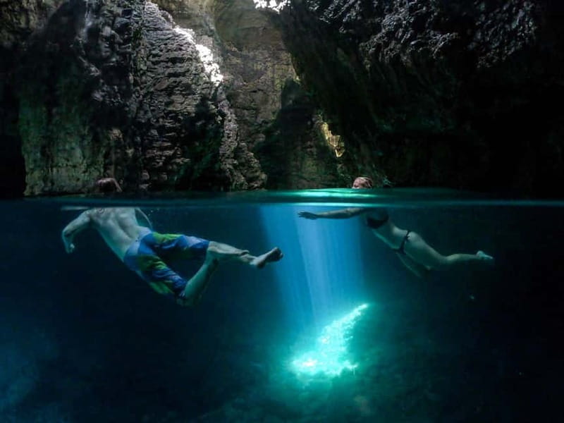 Pula: Cave Kayak, Snorkeling, Cliff Jumping All-in-one Tour - Swimming beneath the opening at Kolombarica