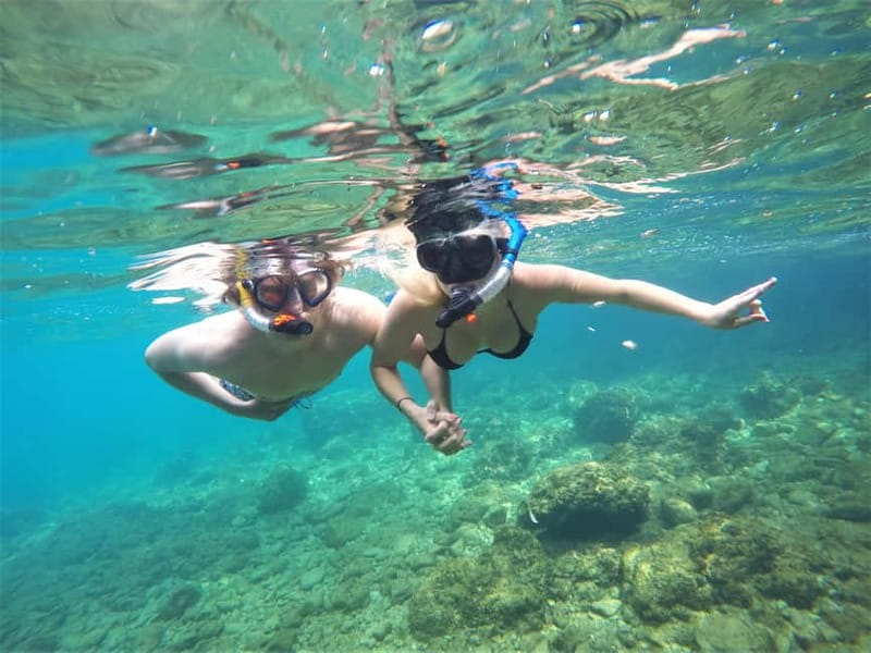 Pula: Cave Kayak Tour, Snorkeling and Island Jumping - Entering the cave with its pigeon colony