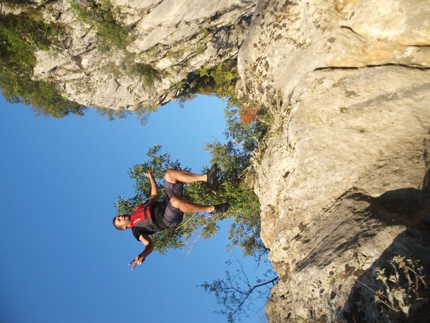 Split: Cetina River Rafting with Cliff Jumping Tour - Standing beneath a spring-water waterfall